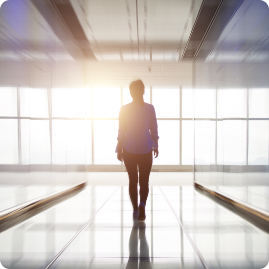 Silhouette of a person in front of windows